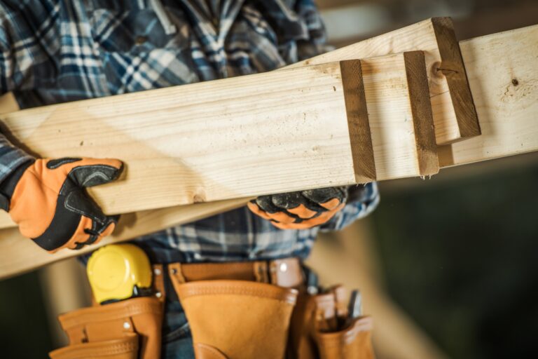 Contractor with Wood Elements in His Hands. House Building Contractor. Closeup Photo. Construction Industry.